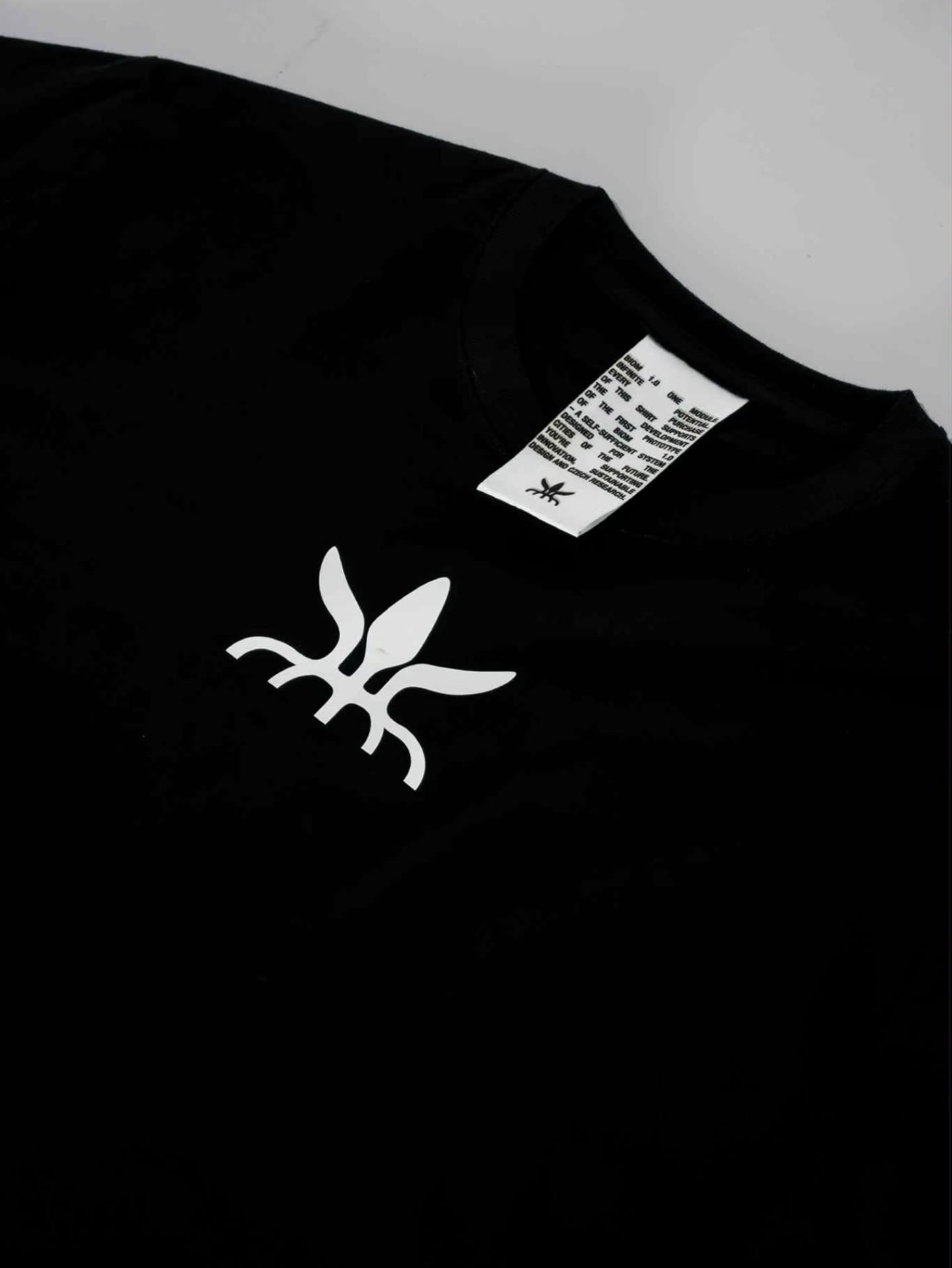 A black t-shirt with the BIOM logo printed on the chest and a woven neck label