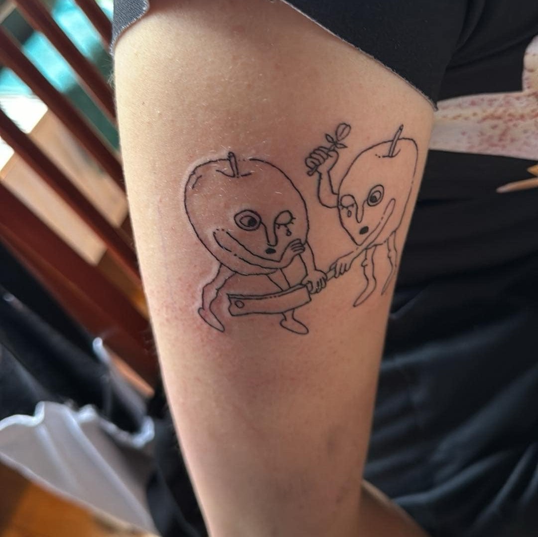 Close-up of a Diplomky-themed tattoo design sketch on a forearm