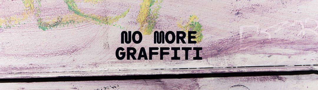A painted wooden panel reading 'No more graffiti' over faded spray-paint marks