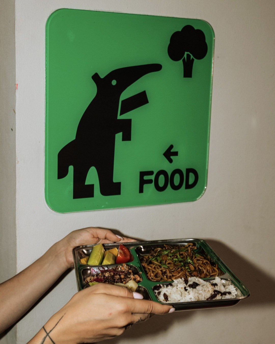 A poster reading a joke about a rumbling stomach and a resolution, in the club's chunky typography