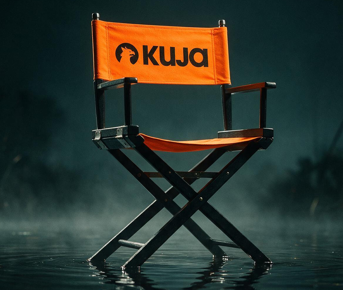 A director's chair with an orange backrest printed with the Kuja logo, standing in shallow water at dusk