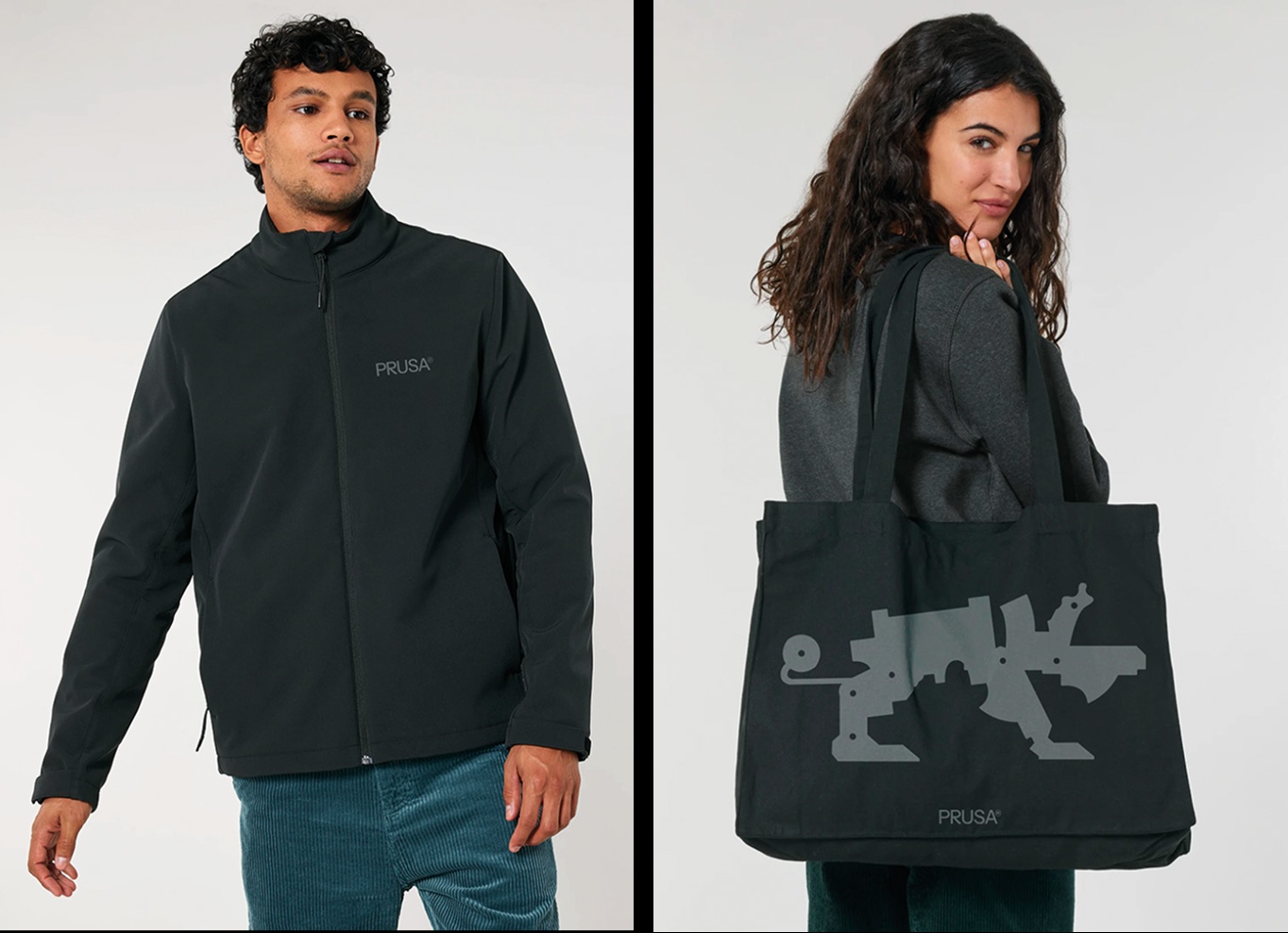 A man wearing a black PRUSA-branded softshell jacket beside a woman carrying a black PRUSA tote bag printed with a gray mechanical creature silhouette